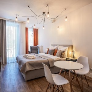 luksusowy apartament w Krakowie z pomarańczowo-szarymi akcentami, idealny na romantyczny pobyt.