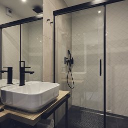 Spacious shower cabin and elegant fixtures in the bathroom