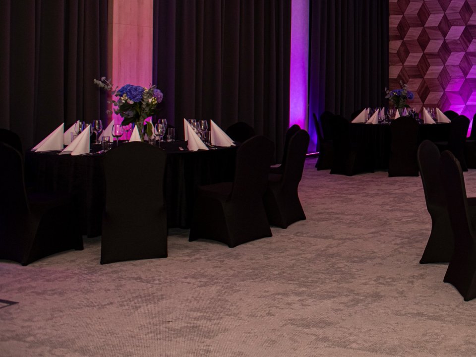 o3meet banquet room before the event — round tables and covered chairs